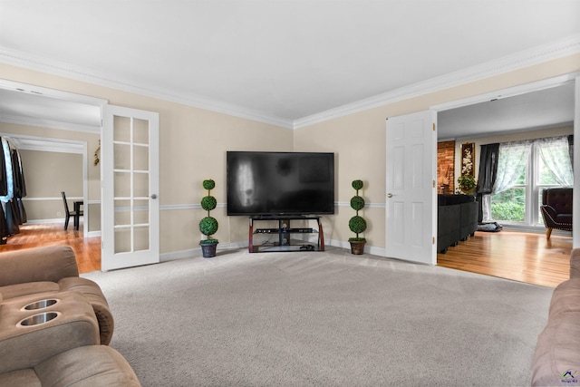 living room with carpet, crown molding, and french doors