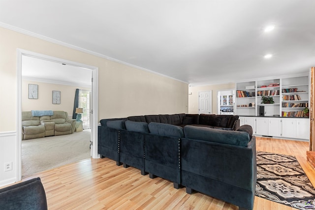 living room featuring light hardwood / wood-style flooring and ornamental molding