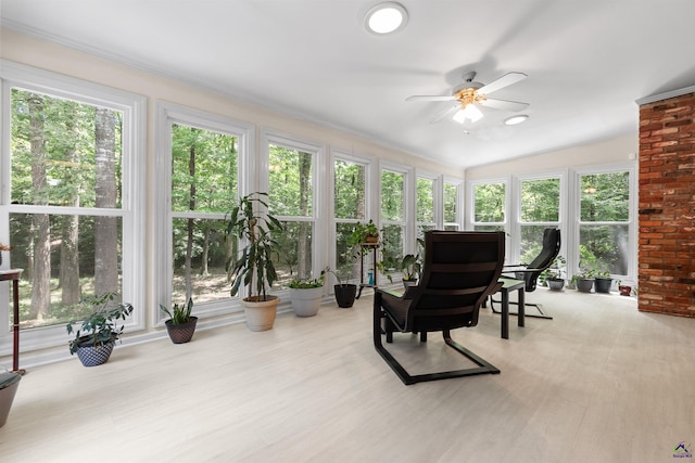 sunroom with ceiling fan and lofted ceiling