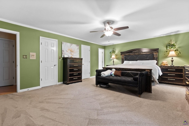 bedroom featuring light carpet, ceiling fan, and crown molding