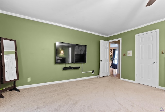 unfurnished bedroom with ceiling fan, crown molding, and light carpet