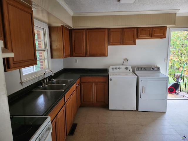 laundry room featuring washer and clothes dryer, sink, a textured ceiling, and ornamental molding