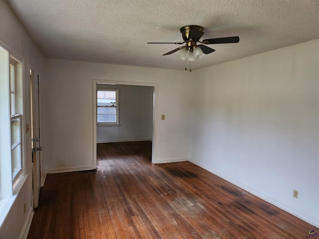 spare room with ceiling fan, dark hardwood / wood-style flooring, and a textured ceiling