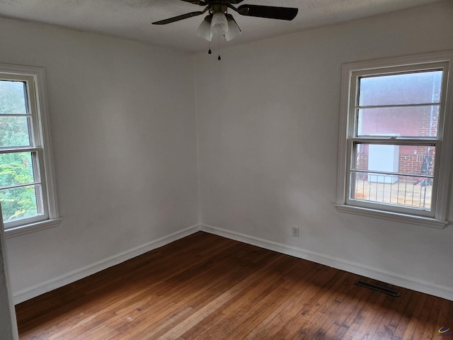 empty room featuring ceiling fan, a textured ceiling, and hardwood / wood-style flooring