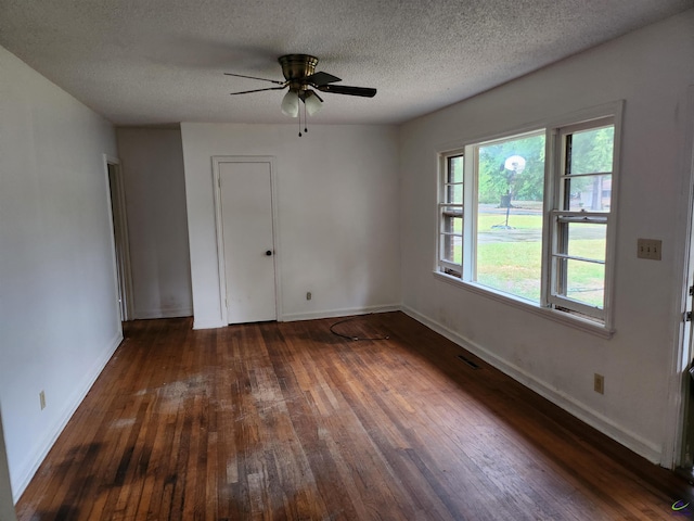 unfurnished room featuring a textured ceiling, dark hardwood / wood-style floors, and ceiling fan