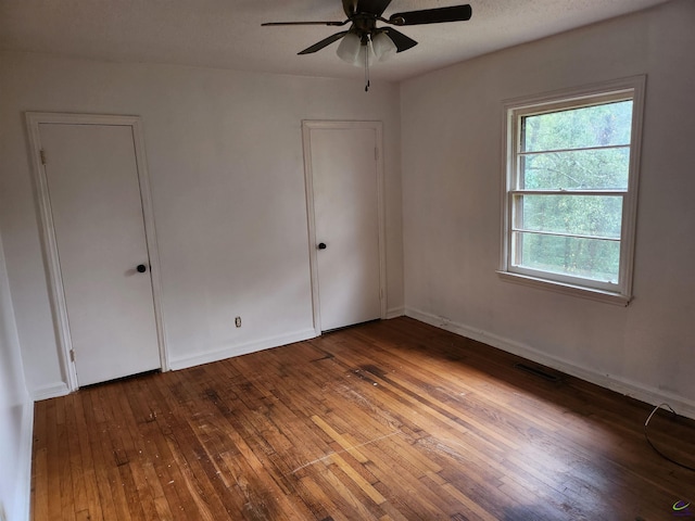 unfurnished bedroom with ceiling fan and hardwood / wood-style flooring