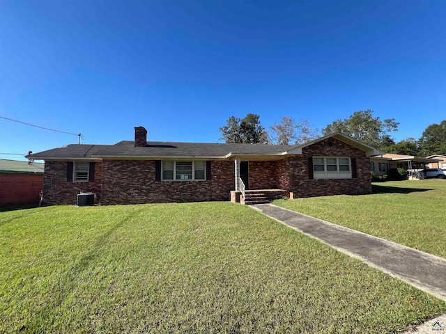 ranch-style home with a front yard and central air condition unit