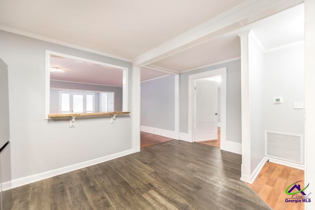 empty room with dark hardwood / wood-style floors and crown molding