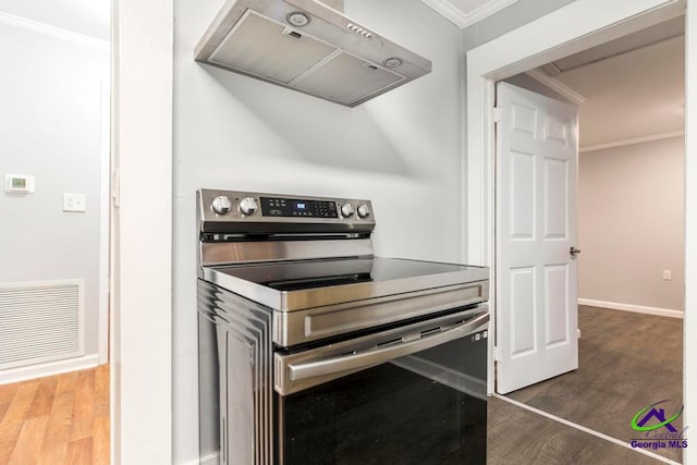 kitchen featuring dark hardwood / wood-style flooring, ventilation hood, stainless steel electric stove, and ornamental molding