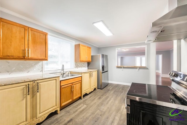 kitchen featuring decorative backsplash, light hardwood / wood-style floors, extractor fan, and appliances with stainless steel finishes