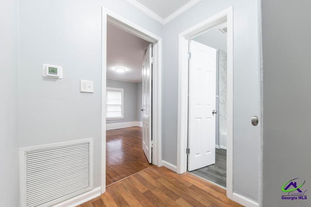 hallway with dark hardwood / wood-style floors and ornamental molding