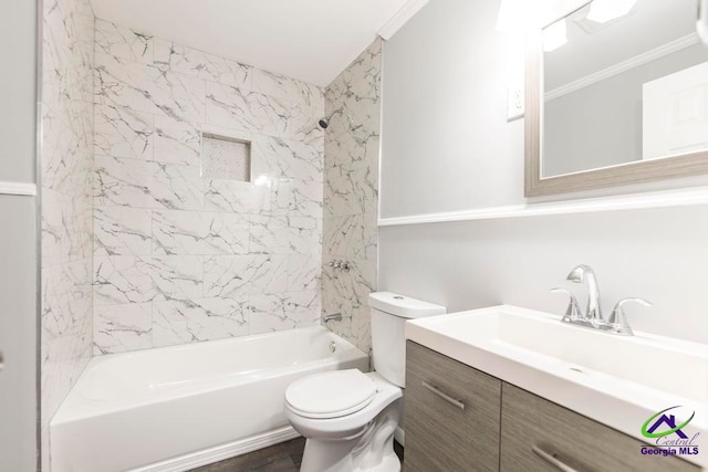 full bathroom featuring toilet, vanity, tiled shower / bath combo, and ornamental molding