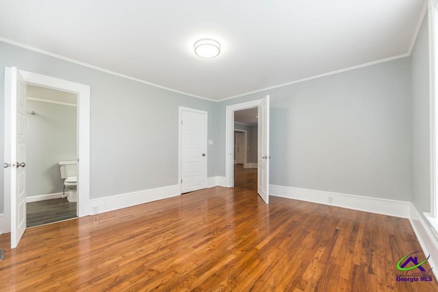 unfurnished bedroom with hardwood / wood-style floors, ensuite bathroom, and ornamental molding