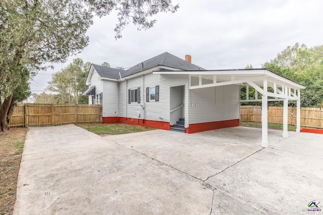 view of side of property with a carport