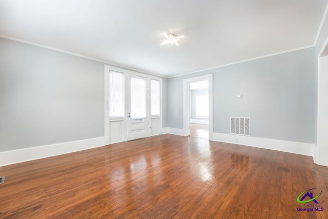 unfurnished room with hardwood / wood-style flooring and ornamental molding