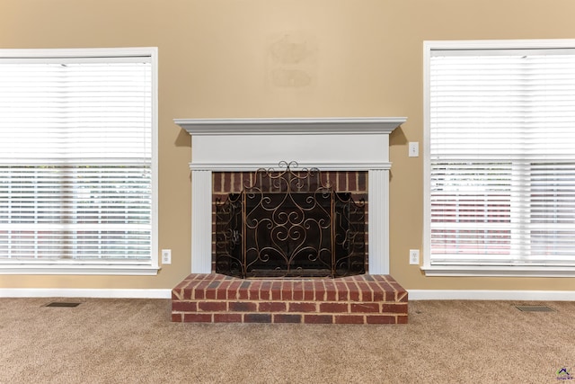 room details featuring carpet and a brick fireplace