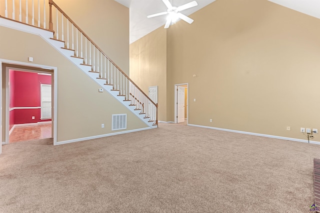 unfurnished living room featuring carpet, ceiling fan, and high vaulted ceiling