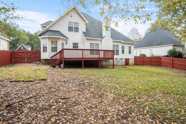 back of property featuring a yard and a deck