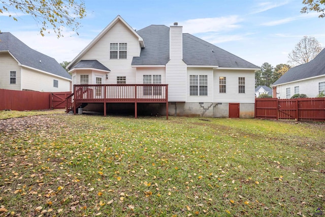 rear view of property with a lawn and a wooden deck