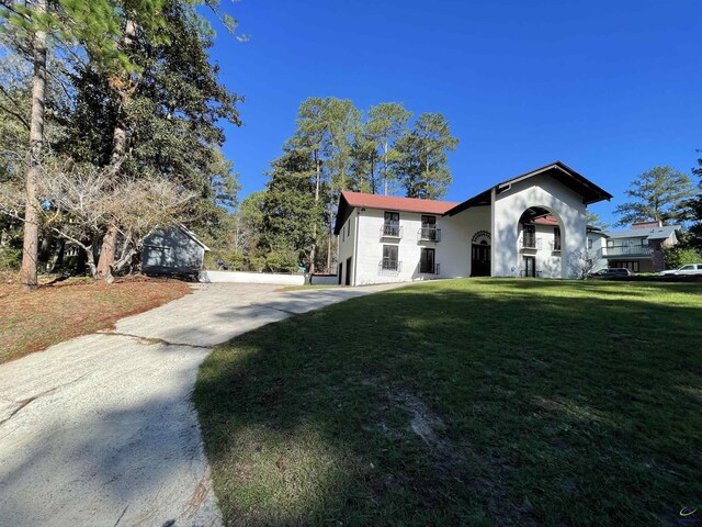 202 Lake Front Dr, Warner Robins, GA 31088 - view of front of house with a front lawn, concrete driveway, and stucco siding