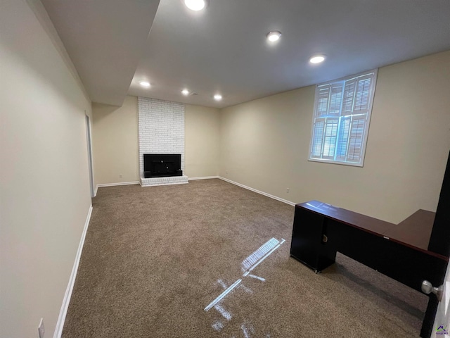 basement with carpet floors and a brick fireplace