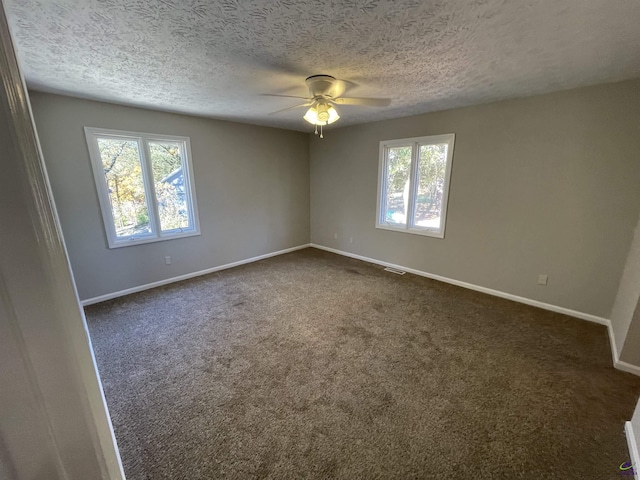 202 Lake Front Dr, Warner Robins, GA 31088 - empty room featuring ceiling fan, baseboards, dark carpet, and a textured ceiling