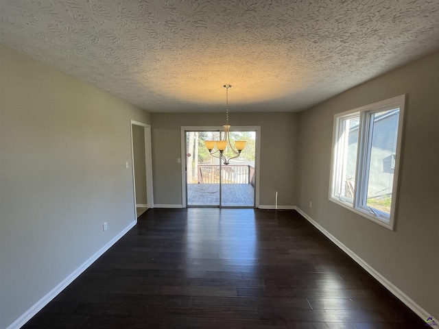 202 Lake Front Dr, Warner Robins, GA 31088 - unfurnished dining area featuring a chandelier, dark wood-style floors, a textured ceiling, and baseboards