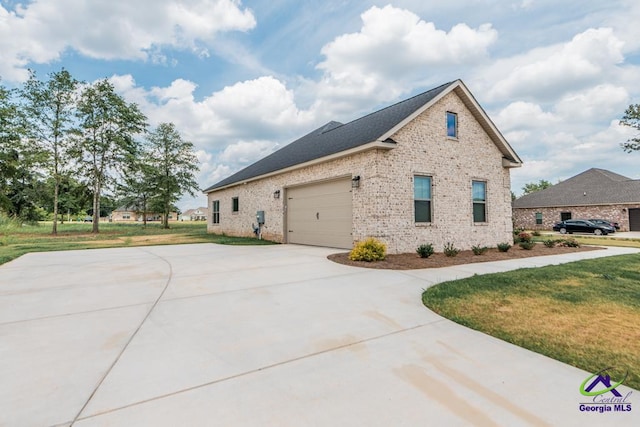 view of property exterior with a yard and a garage