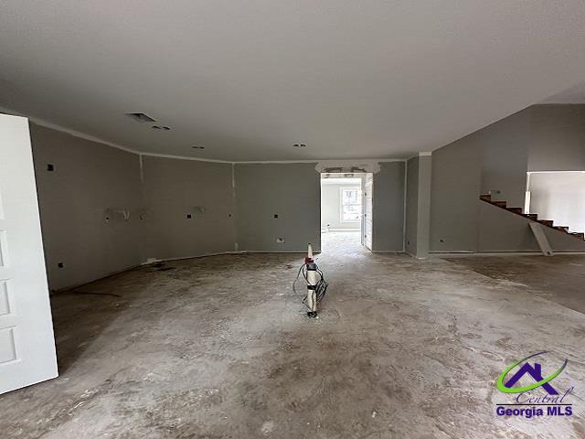 spare room featuring stairs and visible vents