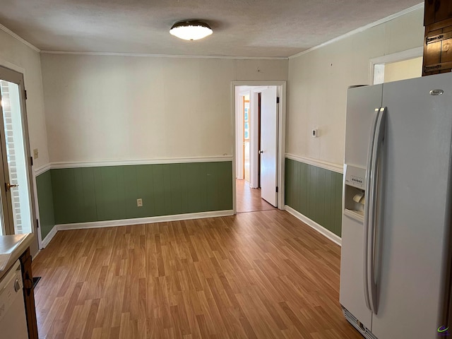 kitchen with a textured ceiling, light hardwood / wood-style floors, white appliances, and crown molding