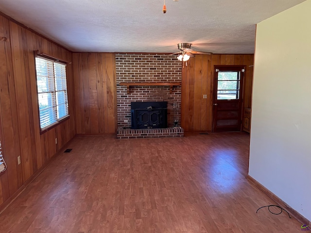 unfurnished living room featuring ceiling fan, hardwood / wood-style floors, and plenty of natural light