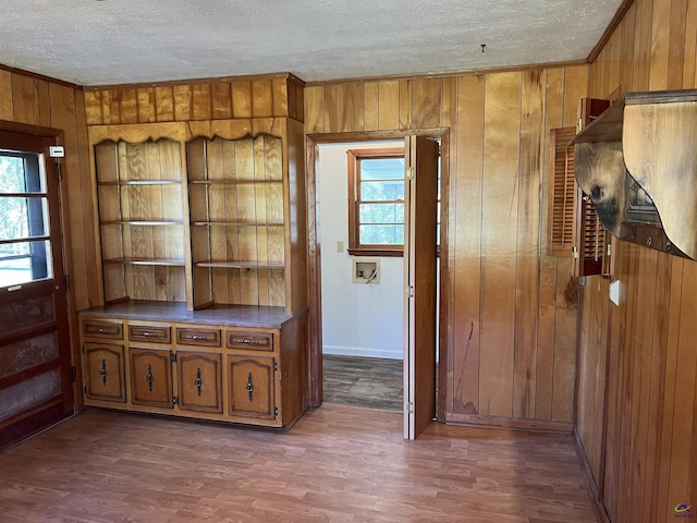 139AND137 Ga Highway 257, Cochran, GA 31014 - unfurnished dining area featuring wooden walls, crown molding, a textured ceiling, wood finished floors, and baseboards