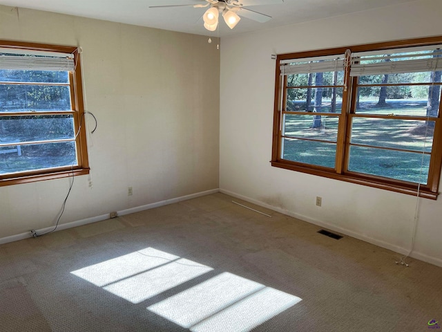 empty room with ceiling fan and carpet