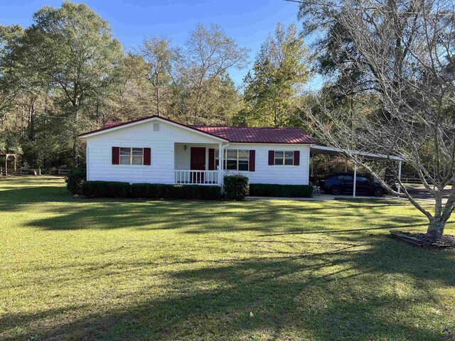 139AND137 Ga Highway 257, Cochran, GA 31014 - ranch-style home featuring covered porch, a front yard, metal roof, and a carport