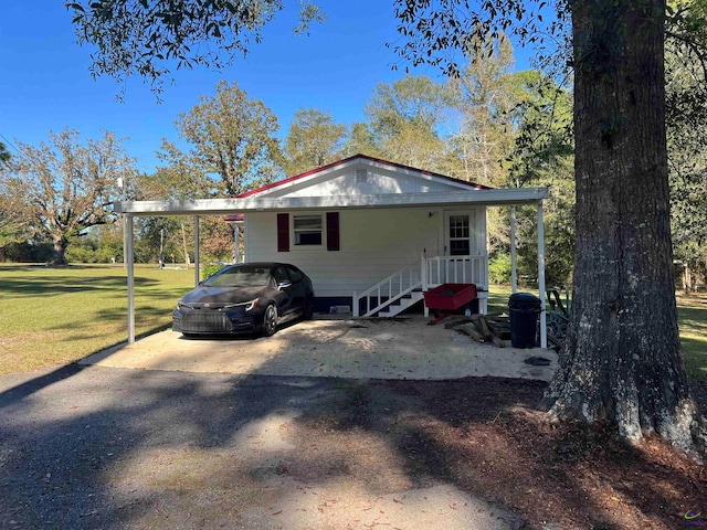 view of home's exterior with a carport and a yard