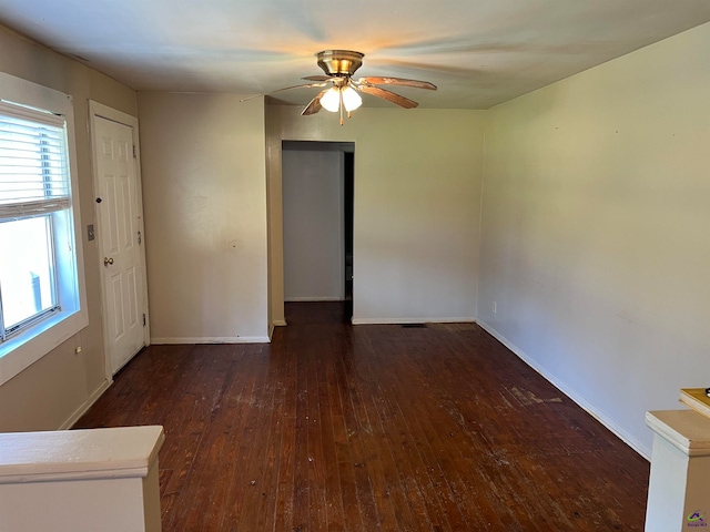 empty room featuring ceiling fan and dark wood-type flooring