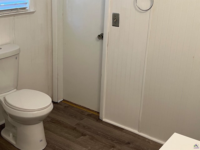 bathroom with wood-type flooring and toilet