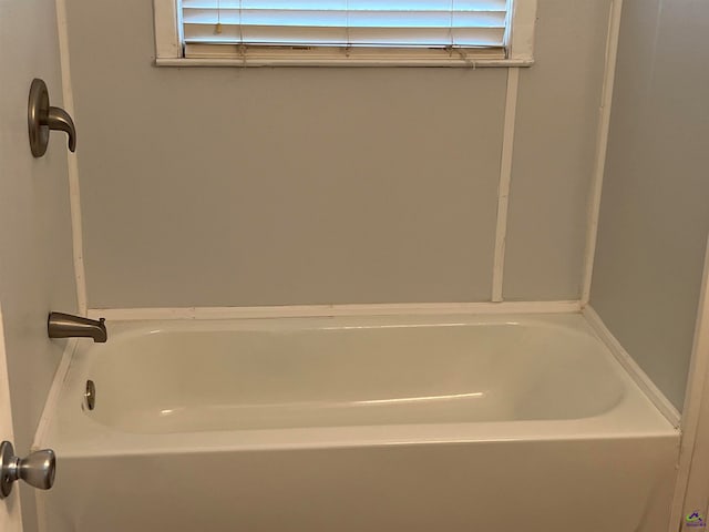 bathroom with a tub to relax in