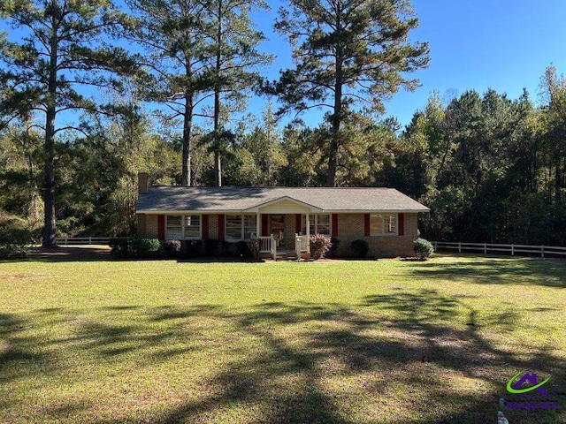 ranch-style house featuring a porch and a front yard