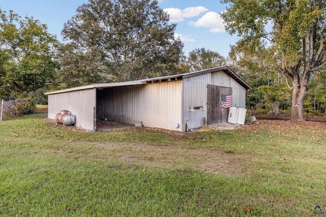 view of outbuilding featuring a yard