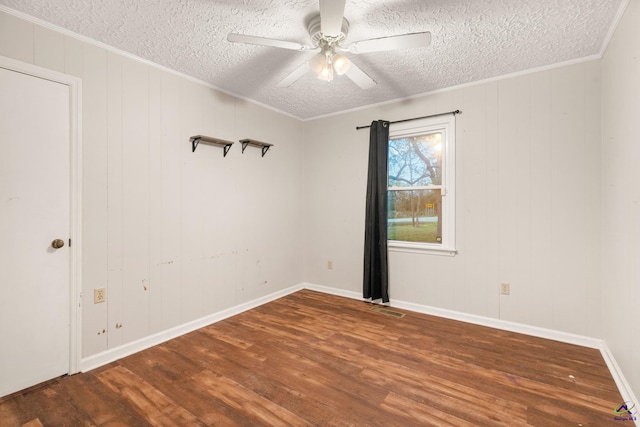 spare room with hardwood / wood-style flooring, ceiling fan, and a textured ceiling