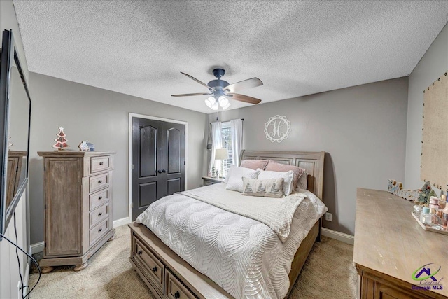 carpeted bedroom featuring ceiling fan, a closet, and a textured ceiling