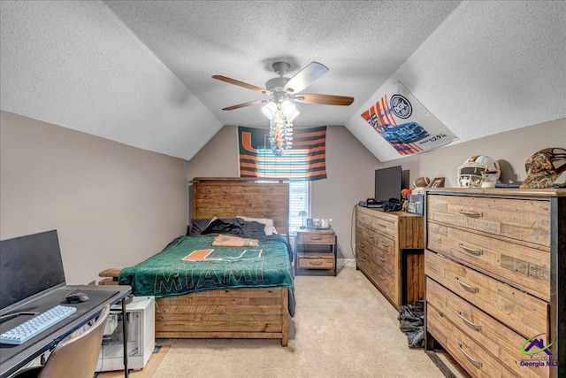 bedroom featuring a textured ceiling, ceiling fan, lofted ceiling, and light carpet