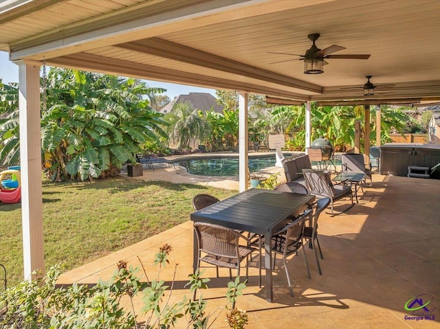 view of patio / terrace featuring ceiling fan and a pool with hot tub