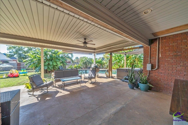 view of patio featuring outdoor lounge area, a hot tub, and ceiling fan