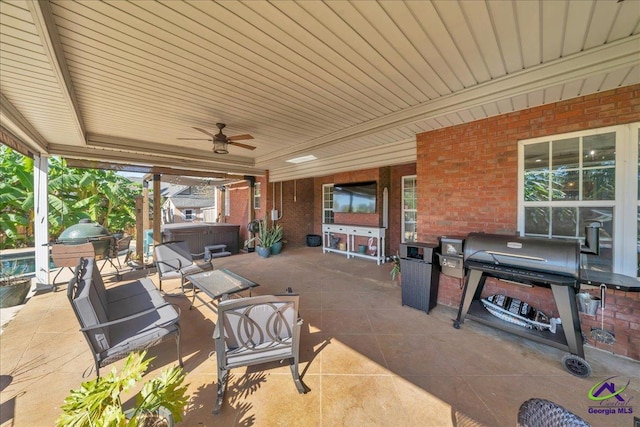 view of patio featuring a hot tub and ceiling fan