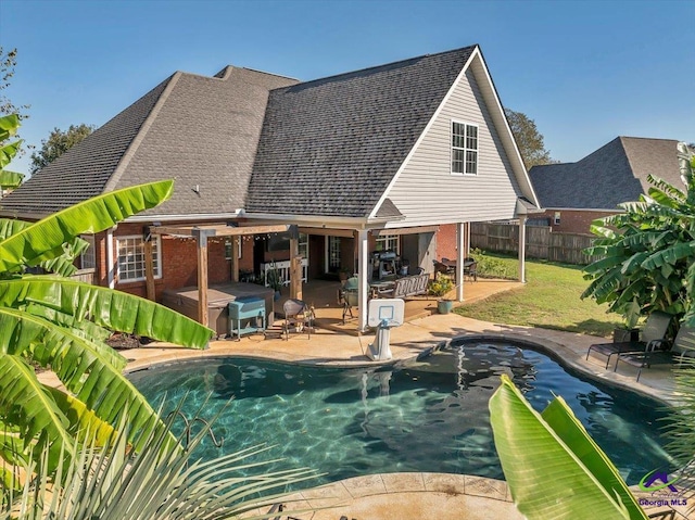 view of swimming pool with a patio area, a jacuzzi, and a yard