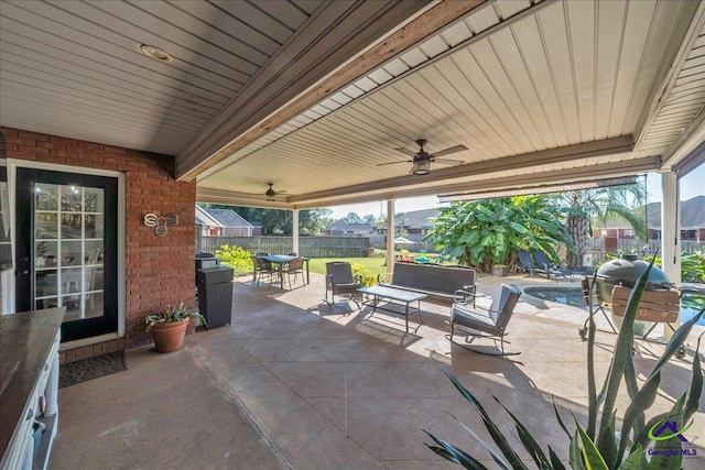 view of patio with outdoor lounge area and ceiling fan