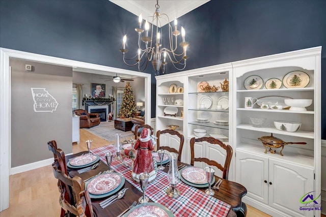 dining room with light hardwood / wood-style floors and a chandelier