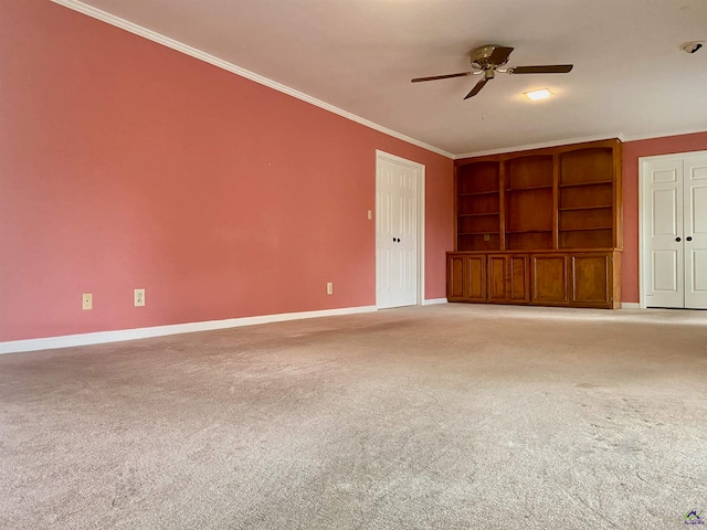 unfurnished living room with light carpet, built in features, ceiling fan, and ornamental molding